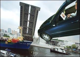 LOOK OUT! An Executive Laptop Steering Wheel Mount alows the multi-tasking executive to make good use of drive time. The laptop stand conveniently mounts onto the steering wheel. Just be careful of bridges in the up position.